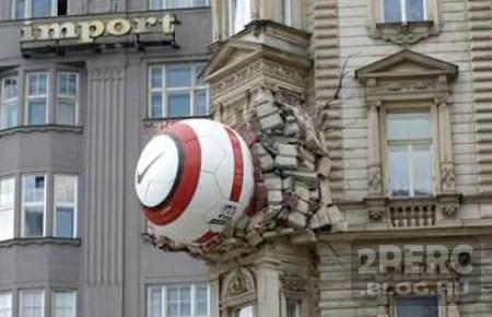 photo of a large soccer ball embedded in the side of a building